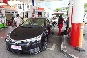 Figure of CNG car for demonstration being fueled at CNG station in Jakarta