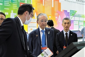 説明を聞くNEDO斎藤理事長（中央）と横島副理事長（右側）の写真