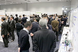 Photo of numerous participants at lively exhibition venue