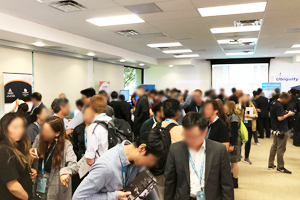 Photo of conference attendees visiting the exhibition area