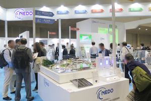 Photo of visitors observing exhibits at NEDO booth