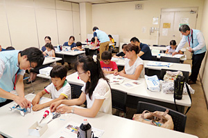 Parents and children making solar-powered cars