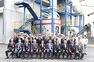 Photo of stakeholders in front of plant