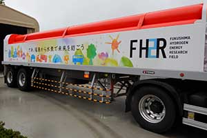 Photo of trailer transporting compressed hydrogen produced at FH2R to hydrogen fuel cell system at Prefectural Azuma Sports Park